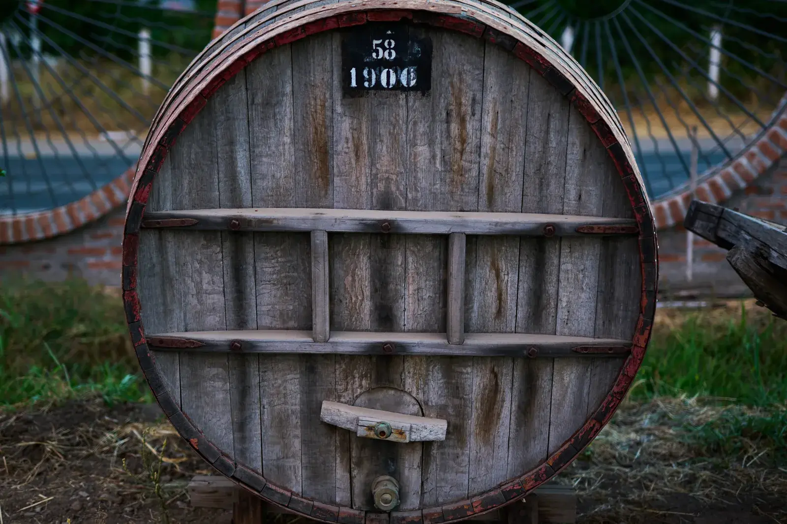 A carved oak wine barrel marked 1906, a symbol of the artisanal craft