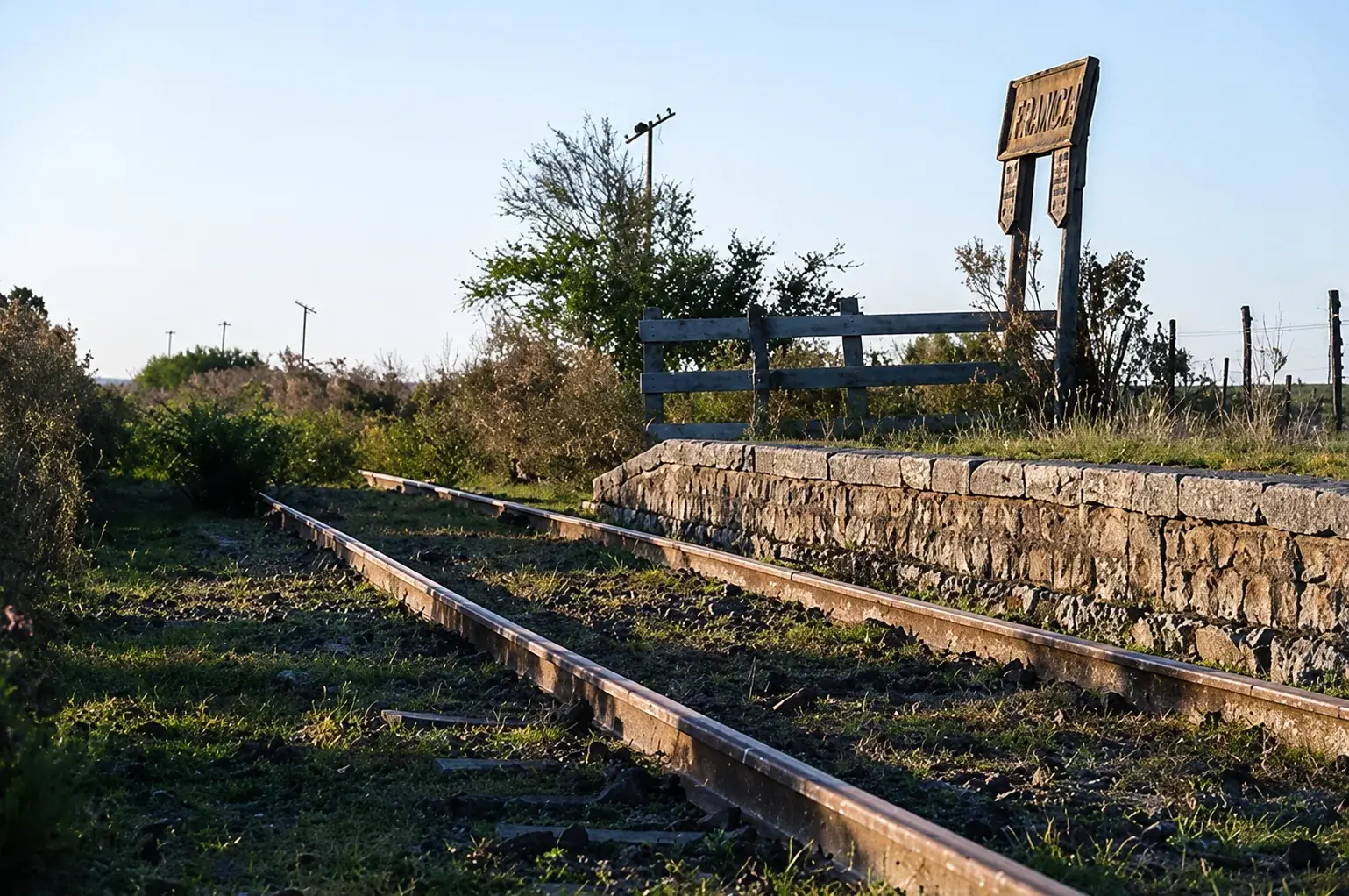The old Estación Francia at golden hour: the railway tracks and the station's wooden sign